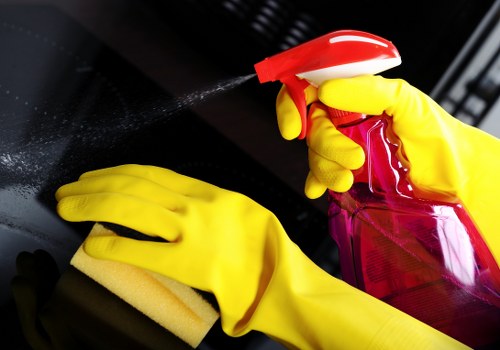 Staff member assessing hoses and warning signs during cleaning
